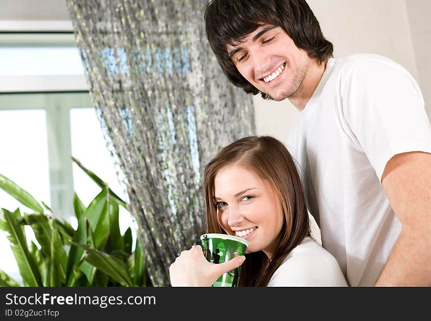 Beautiful girl with green cup and boy. Beautiful girl with green cup and boy