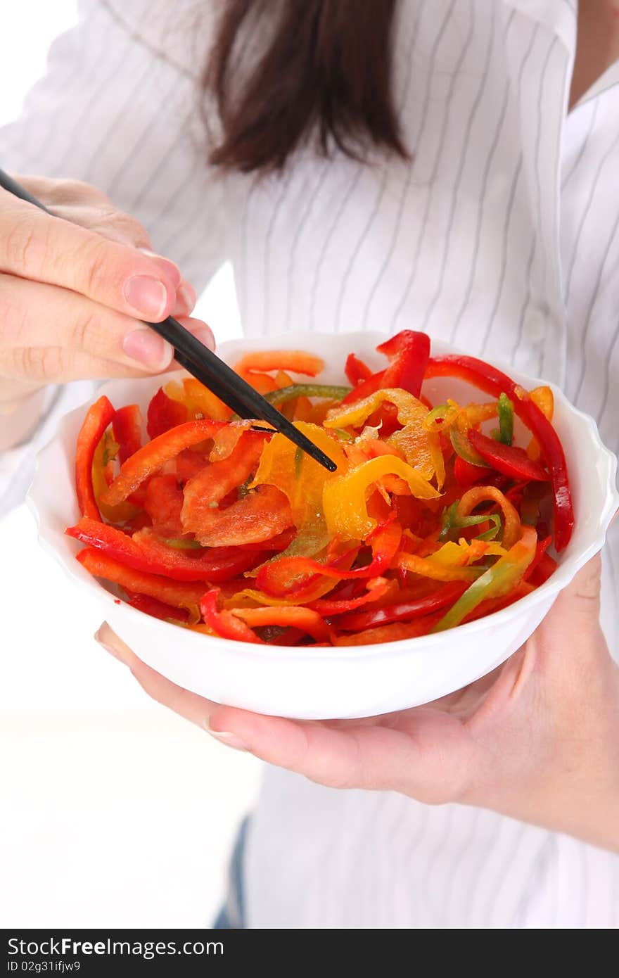 Chopsticks, bowl and peppers in close up