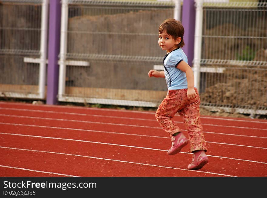 A little girl running on the runway. A little girl running on the runway