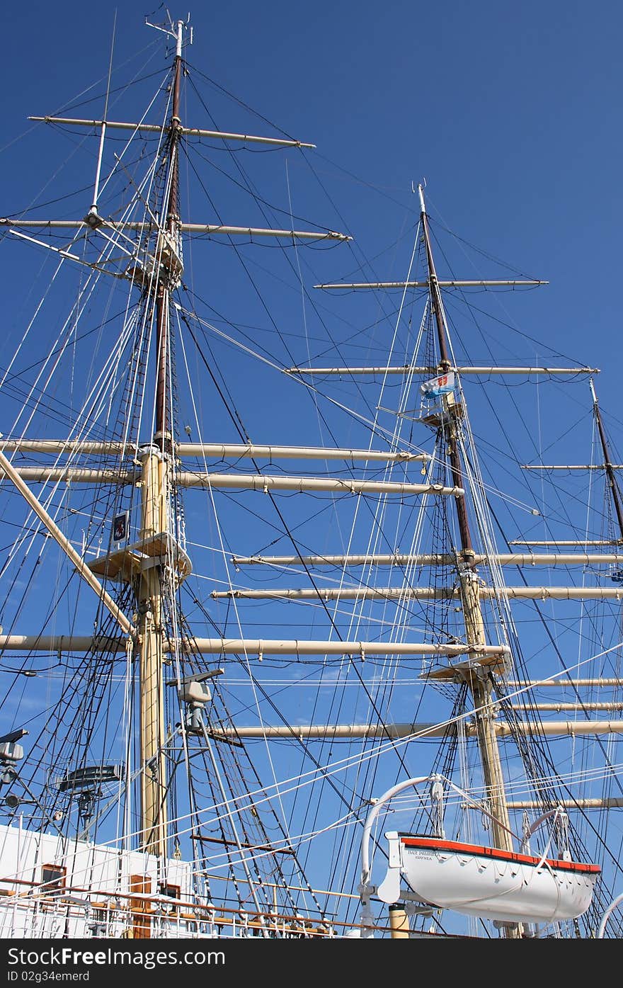 Two masts and lifeboat on white sailing boat