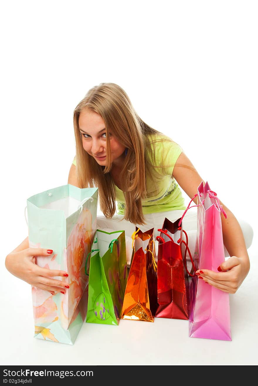 The beautiful girl with packages isolated on a white background