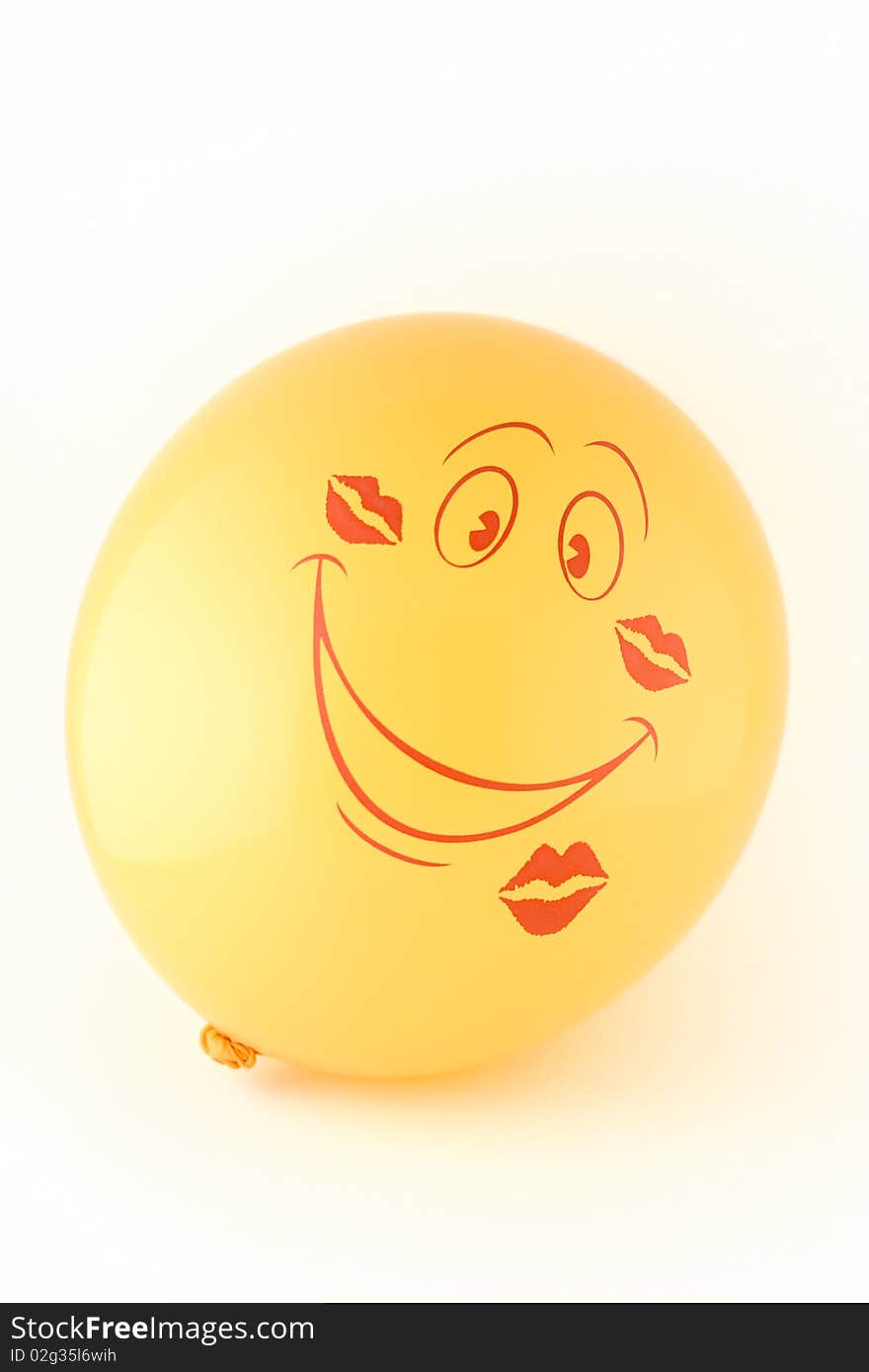 Smiling yellow balloon in the imprints kisses