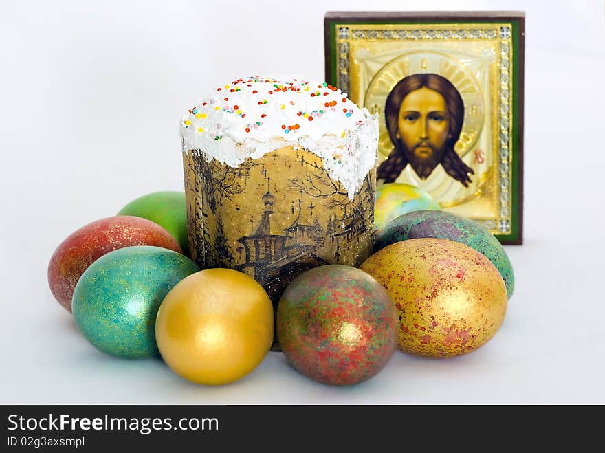 Easter eggs and Easter cake against an icon