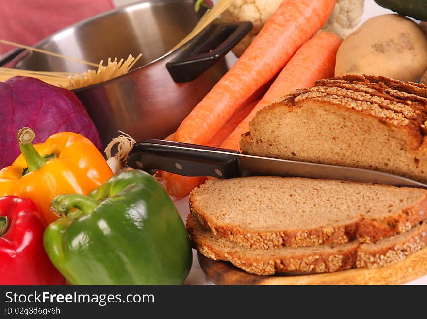 Bread, carrot, red cabbage and peppers in close up. Bread, carrot, red cabbage and peppers in close up