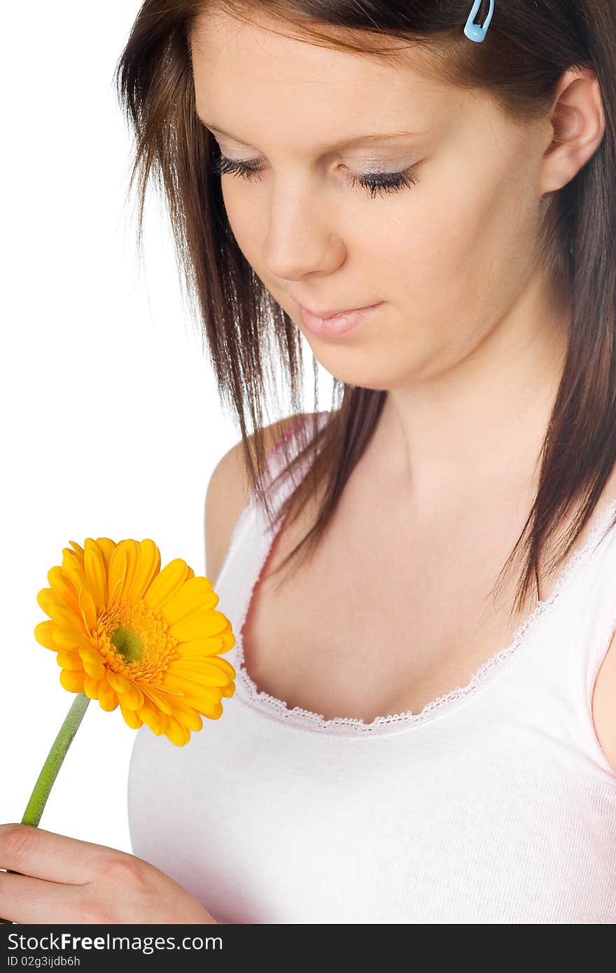 Girl with a orange gerbera flower in the hand isolated on white background. Girl with a orange gerbera flower in the hand isolated on white background