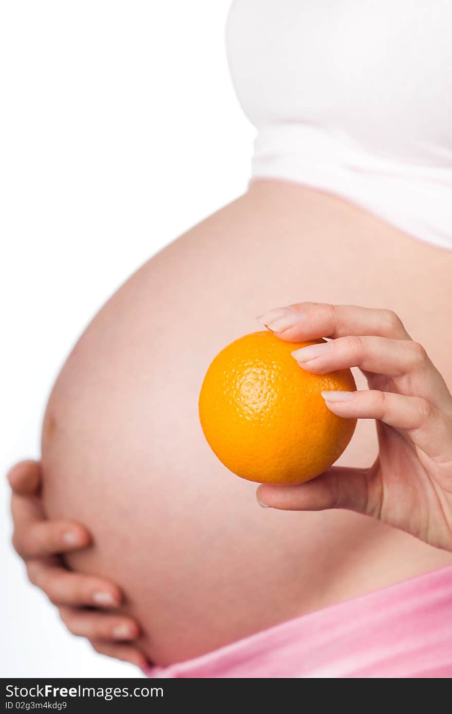 Pregnant girl with an healthy orange in the hand. Pregnant girl with an healthy orange in the hand