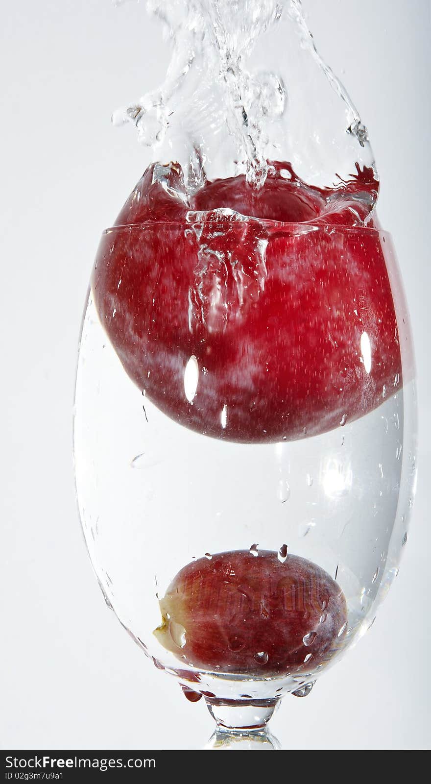 Splash of water with grape fruit and cherry