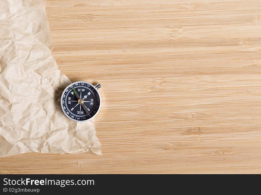 Background with brown paper and compass