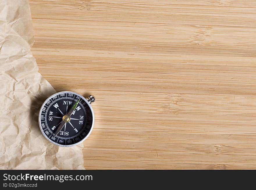 Background with brown paper and compass