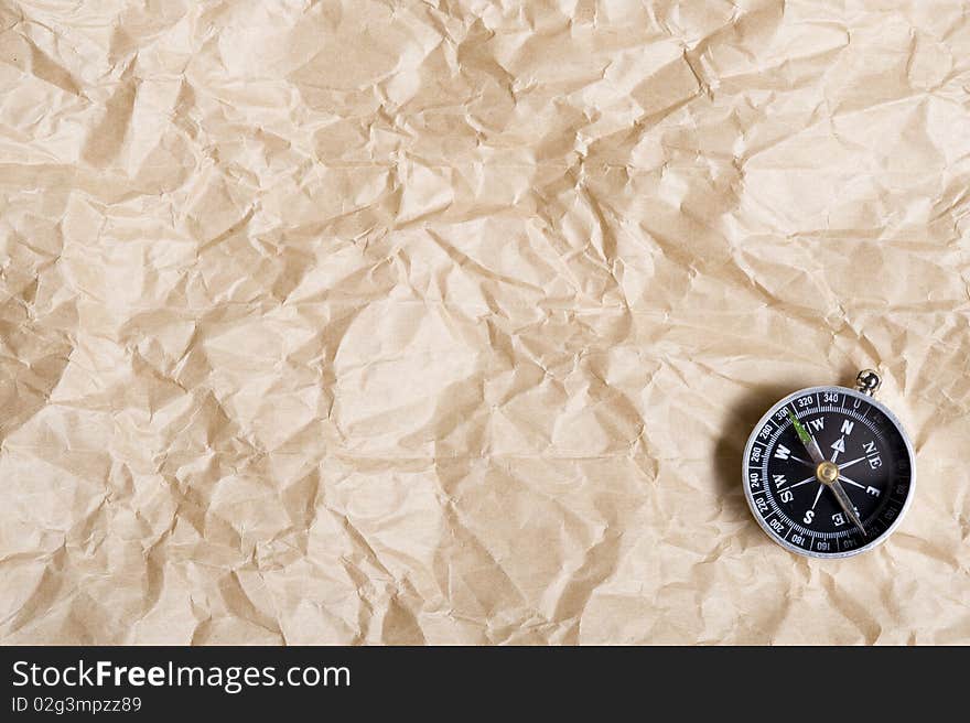 Background with brown paper  and compass. Background with brown paper  and compass