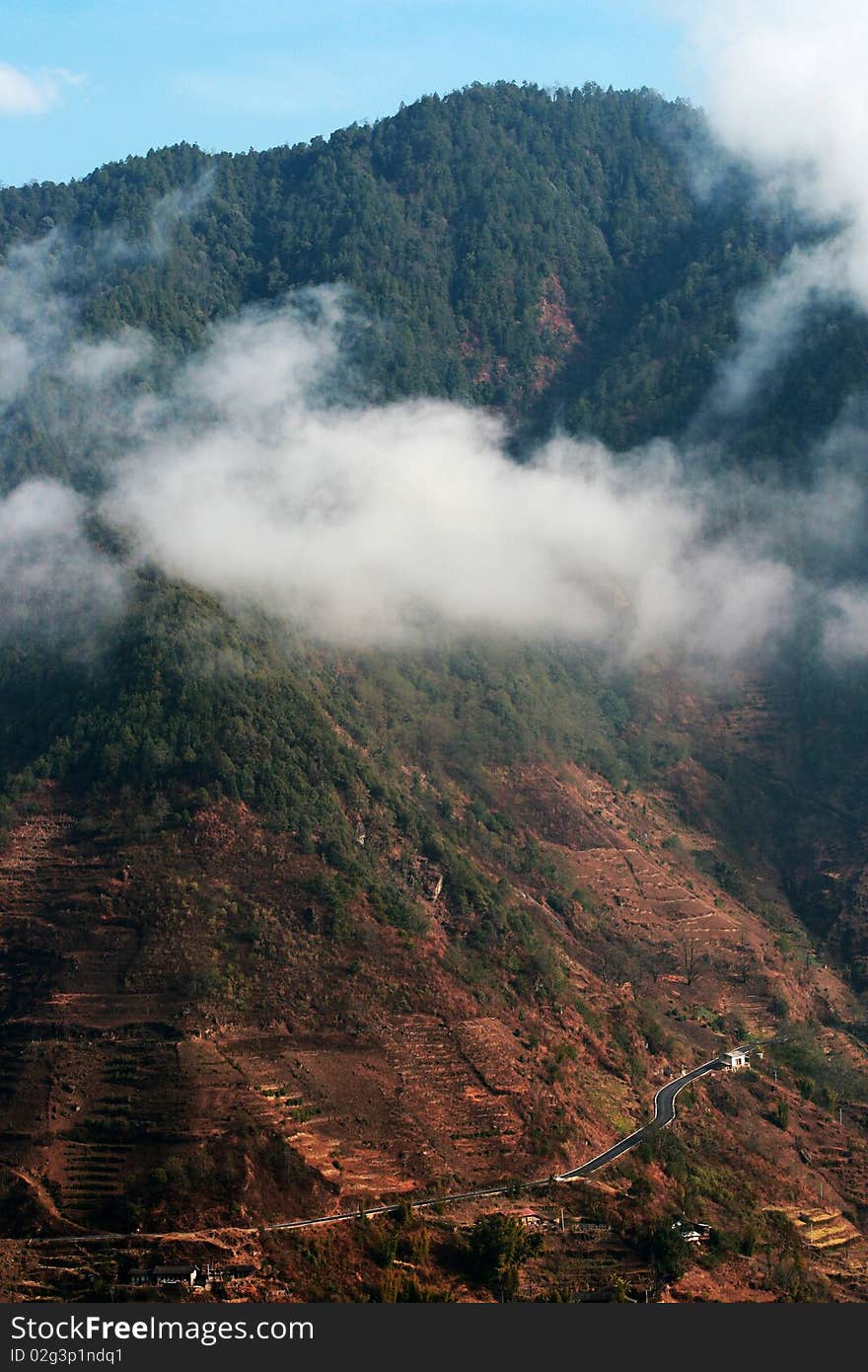 A view of mountain in Yunnan, China. Surround with clouds.