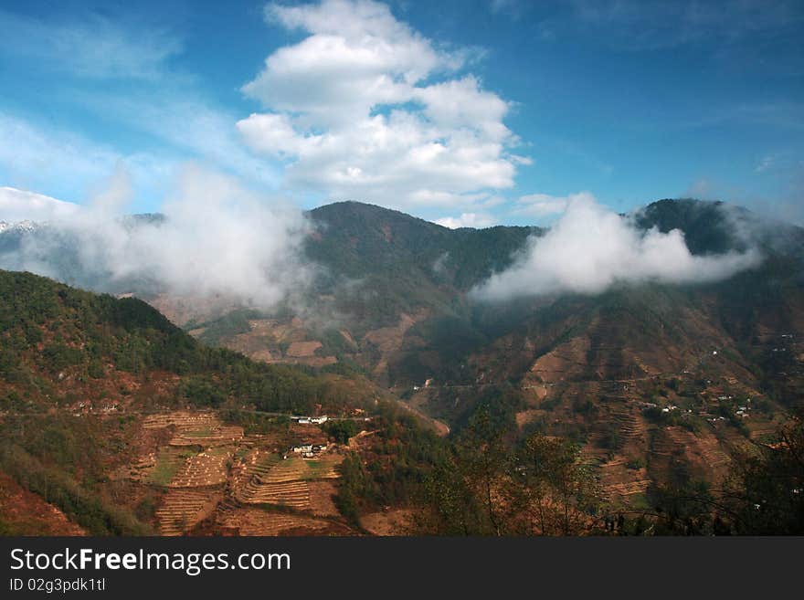 A view of mountain in Yunnan, China. Surround with clouds.