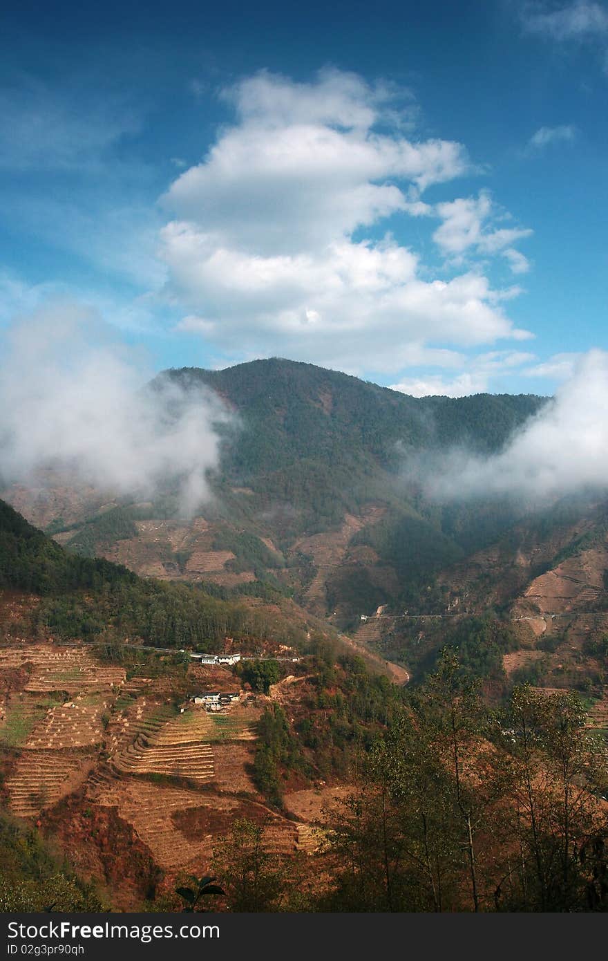 A view of mountain in Yunnan, China. Surround with clouds.