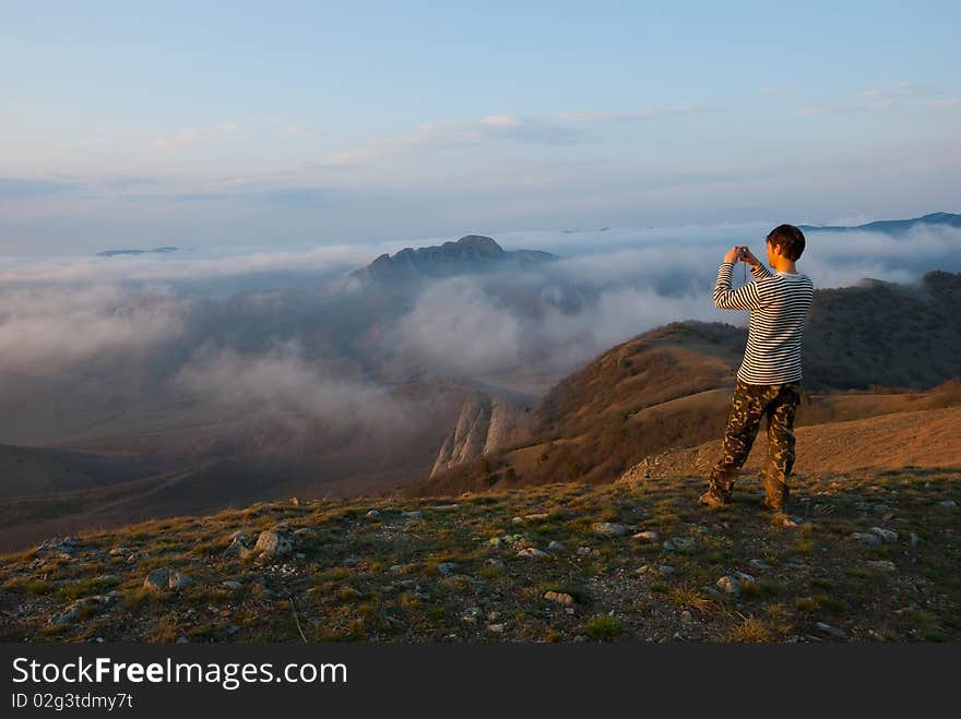 Hiker take a picture in mountains