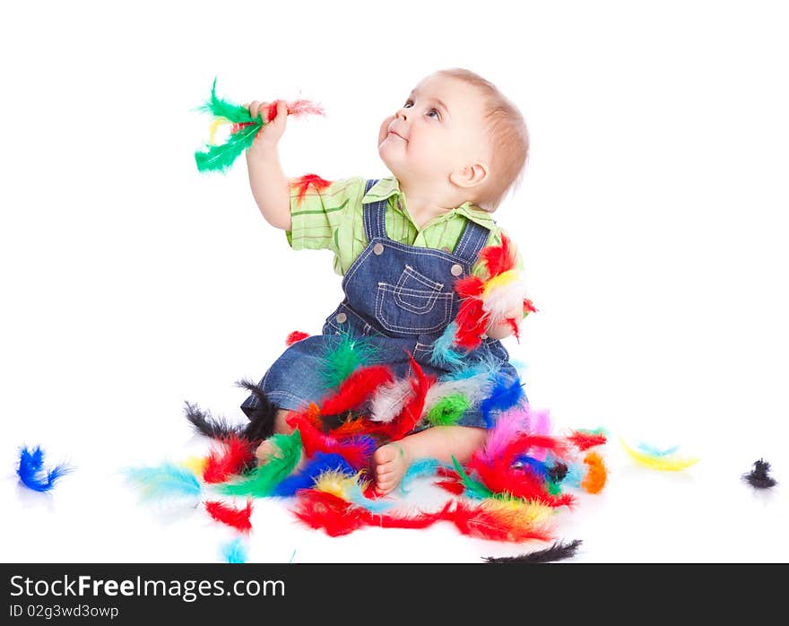 Little boy is sitting on a flow with feathers. Isolated on white background