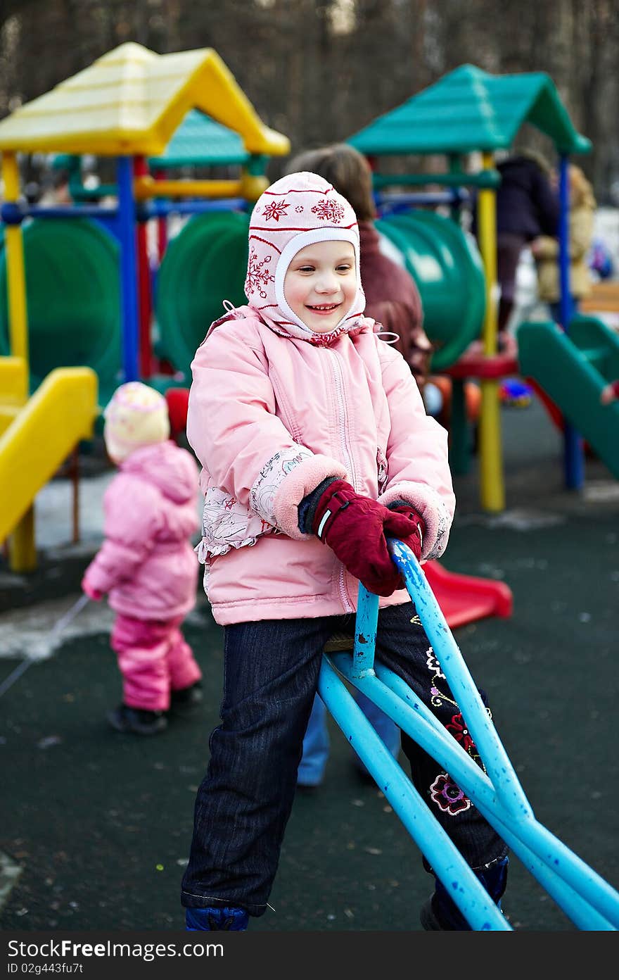 Little girl on a walk in swing