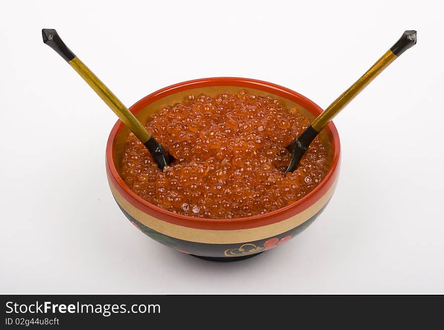 Red caviar in Russian national bowl on a white background