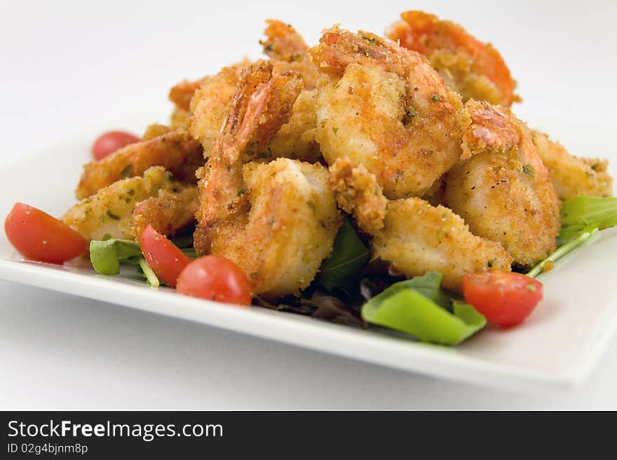 Fried Shrimp with mixed field greens on white plate