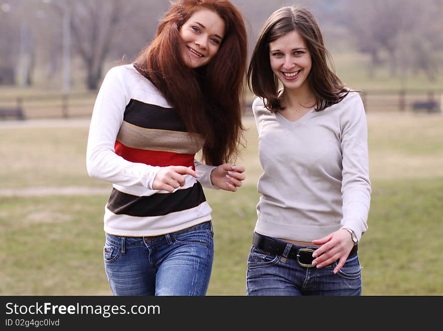 Two cheerful girls in the spring park