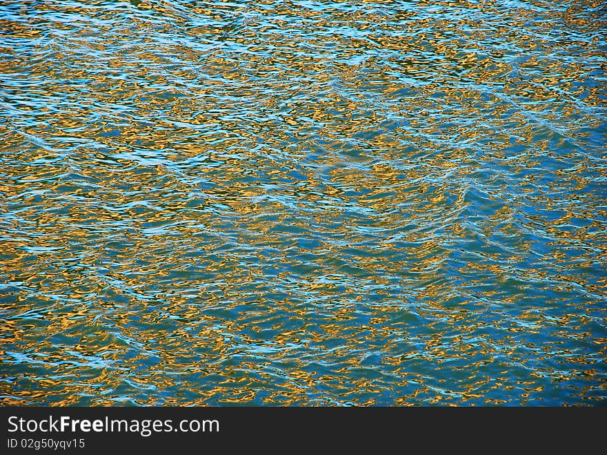 Natural river water surface in blue and gold