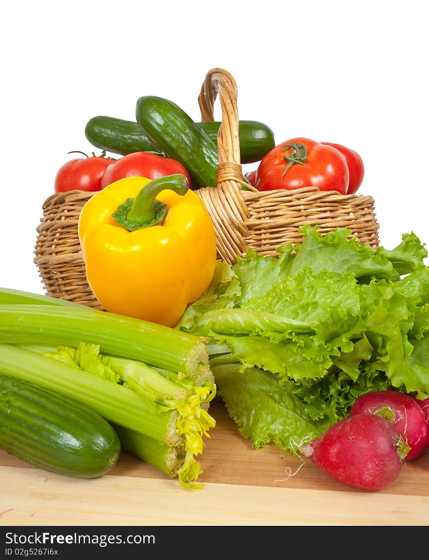 Ripe vegetables in basket on white background