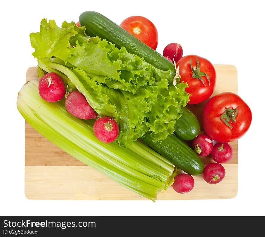 Vegetables on wooden cutting board  over white background