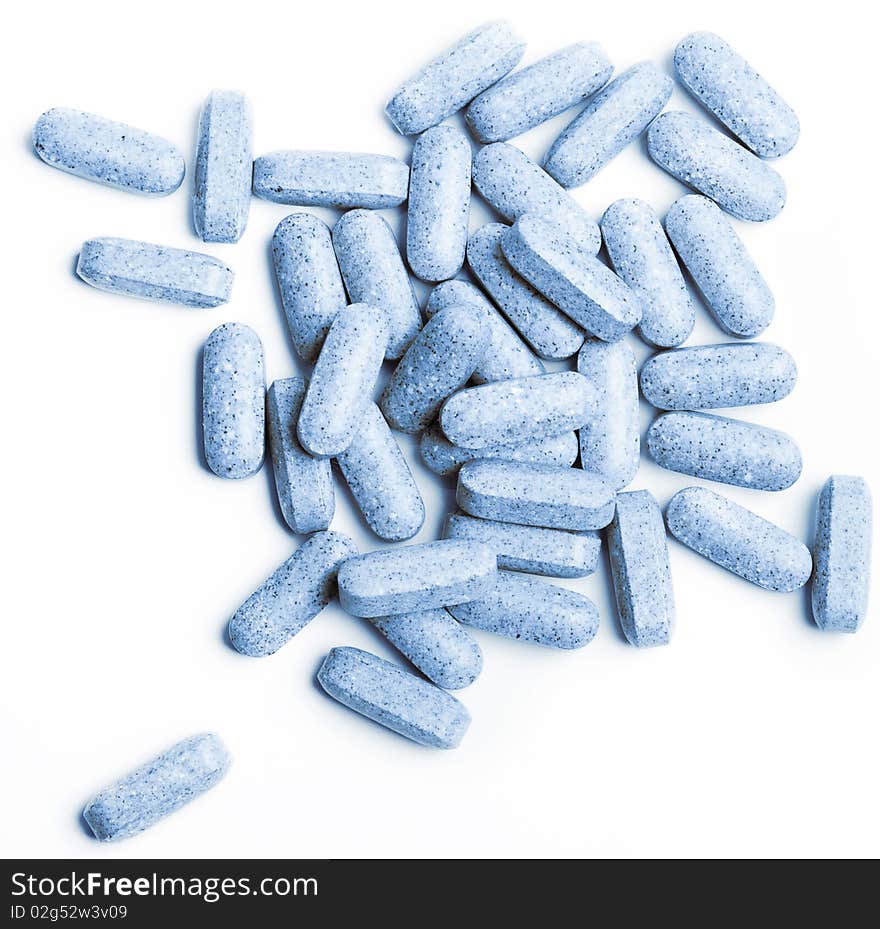 Macro of blue pills isolated on white background