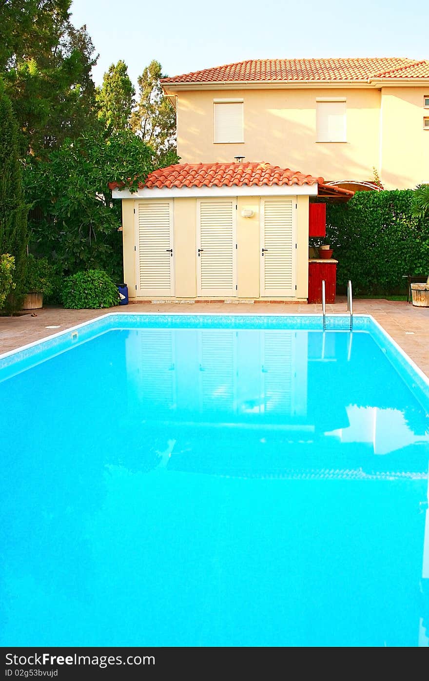 House and swimming pool, vertical picture.