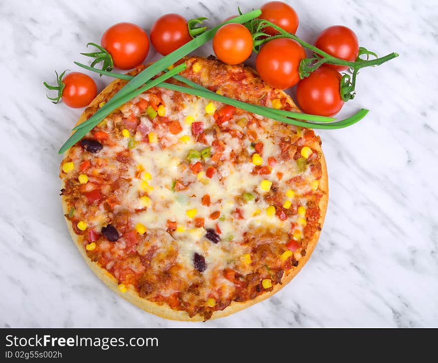 Pizza with red cherry tomatos and green onion