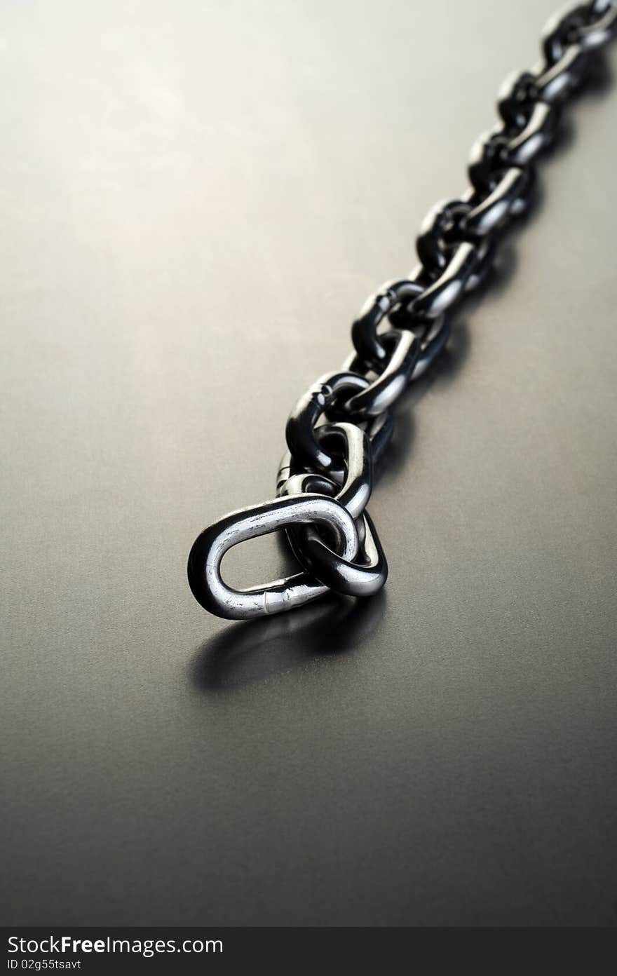 Steel chain on a metal background. Steel chain on a metal background