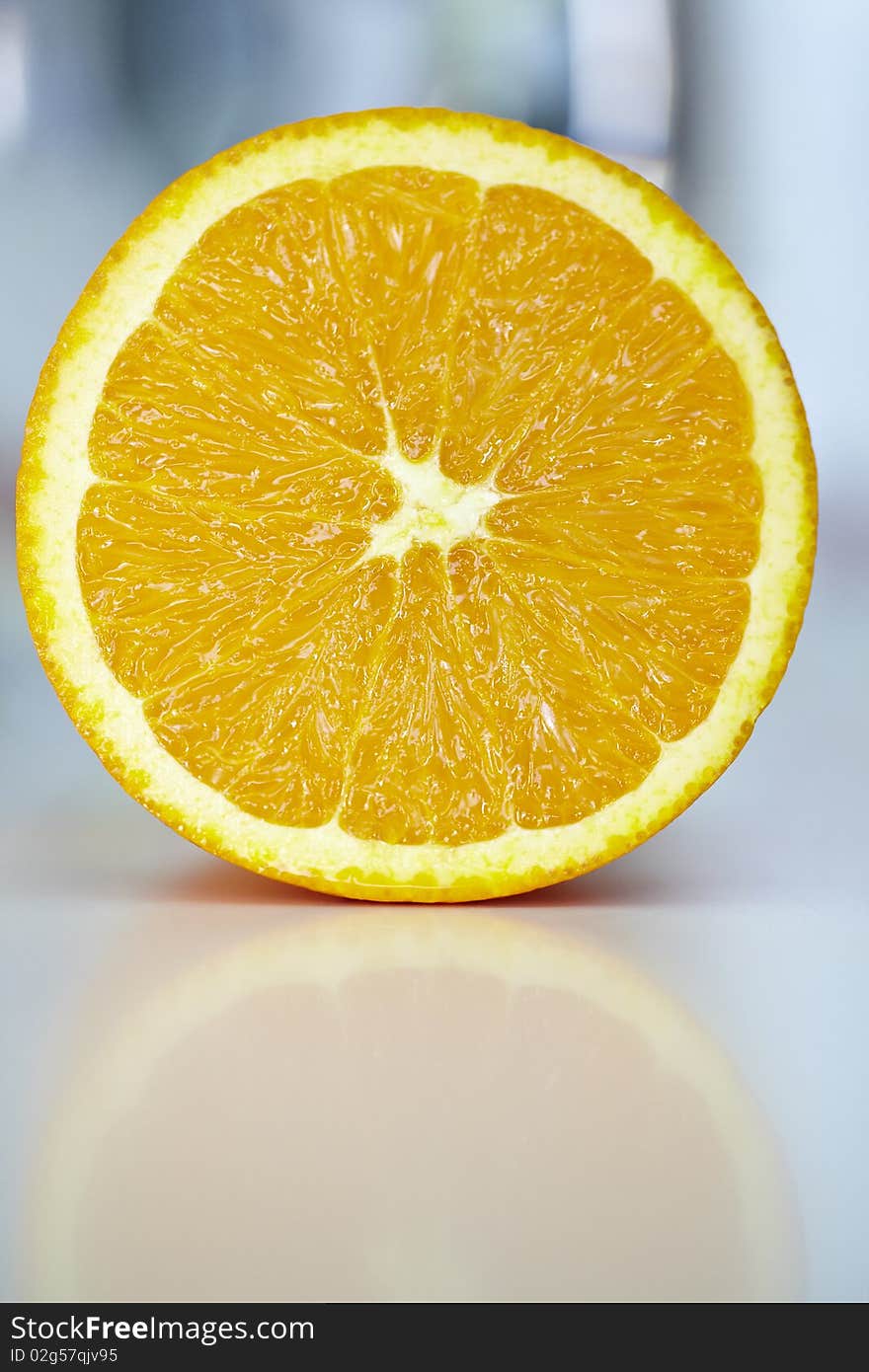 Orange fruit cut in half with reflection. Orange fruit cut in half with reflection.