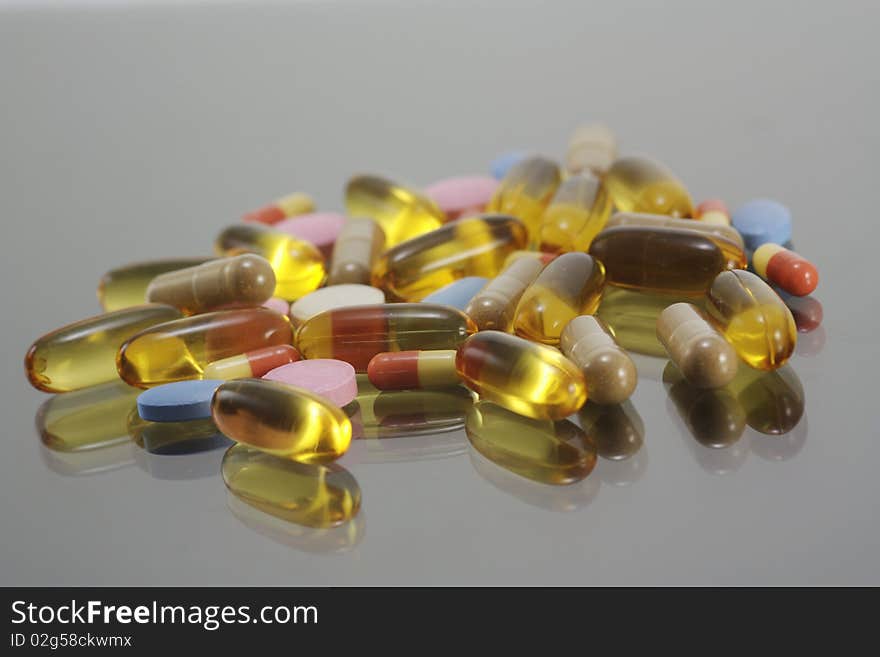 Vitamin gel capsule on reflection background. Vitamin gel capsule on reflection background