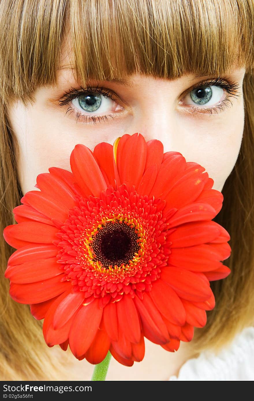 Portrait of a young woman with red flower gerbera