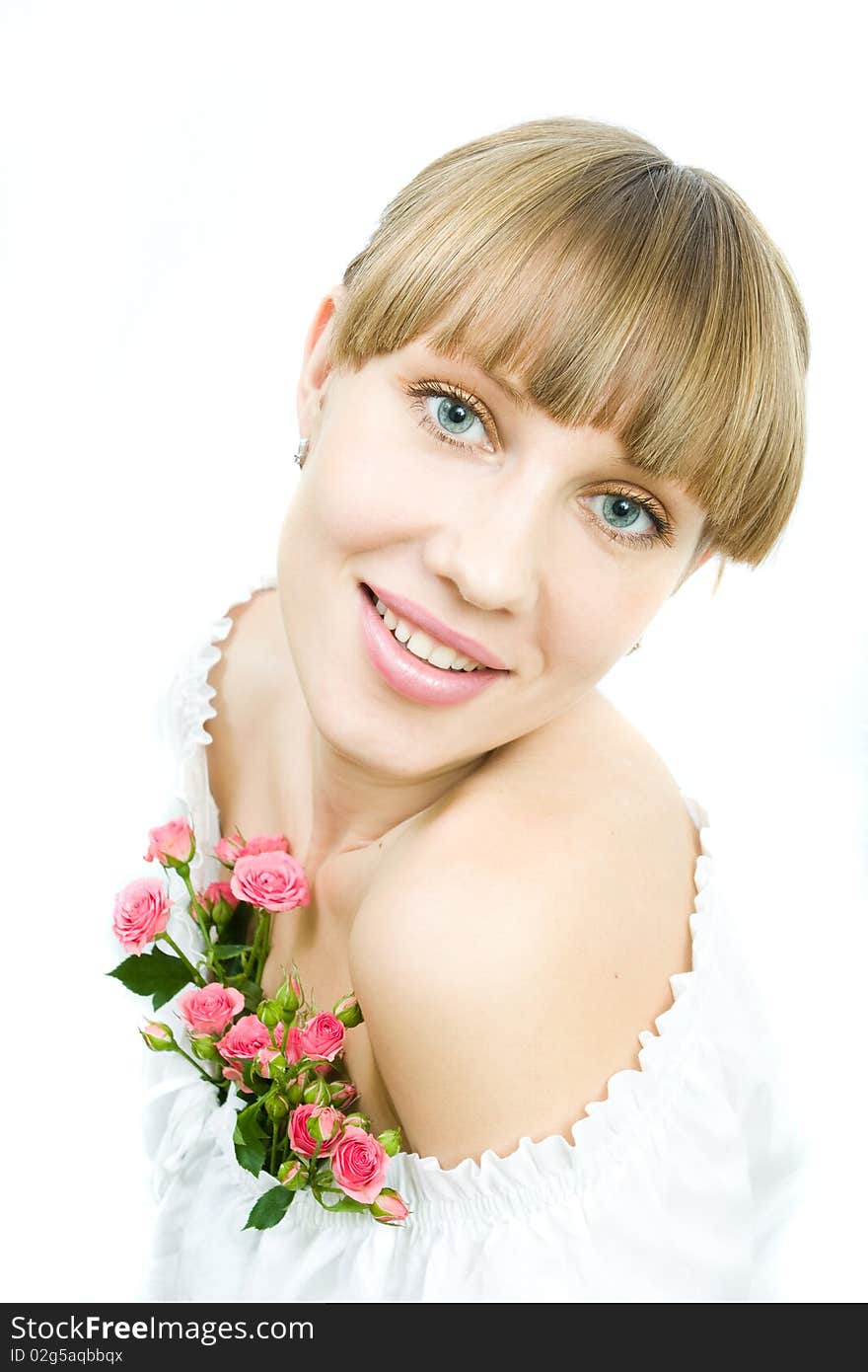 Portrait of a young woman in a white blouse with roses on a white background