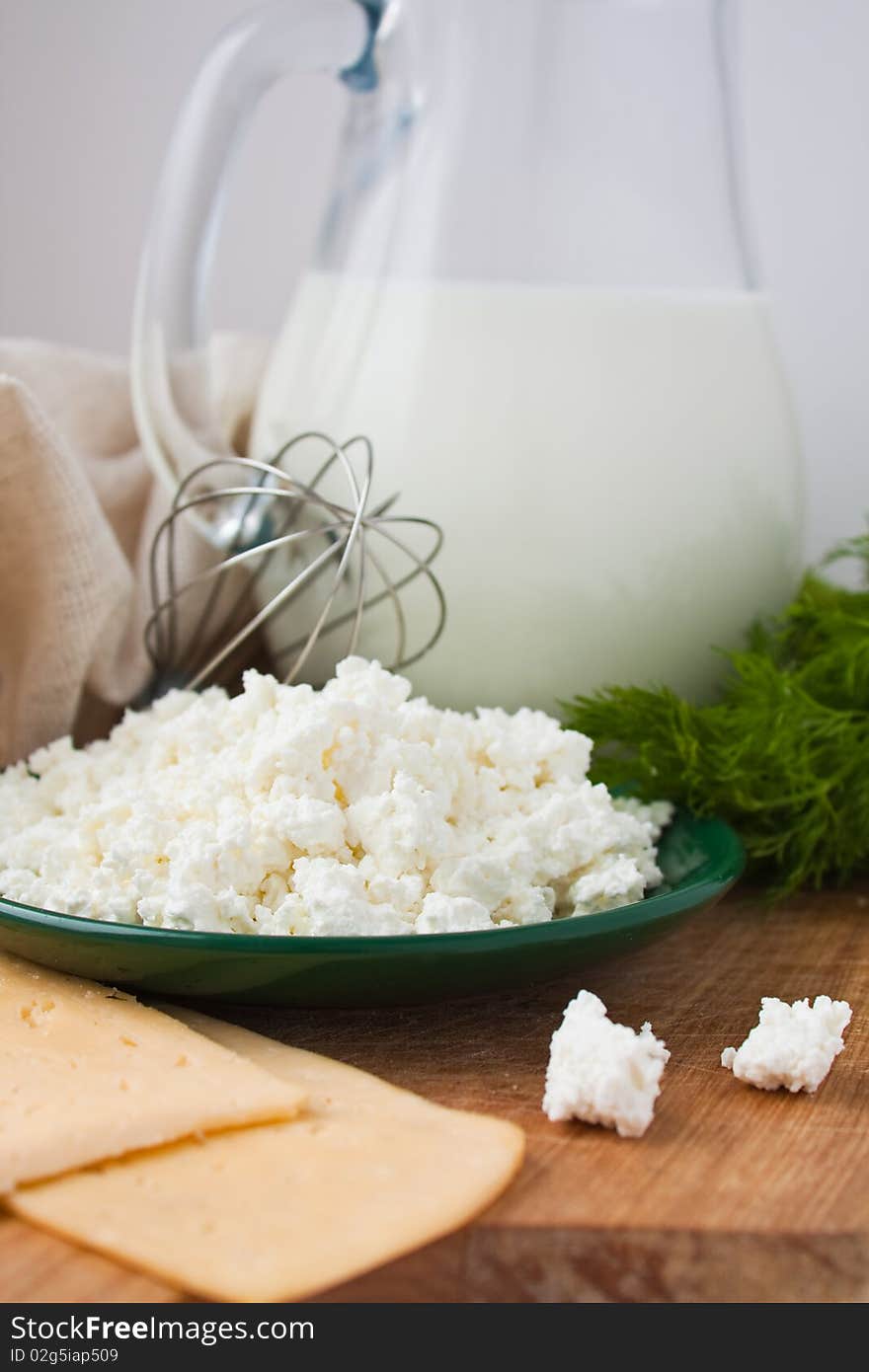 Sandwiches with cheese, dill, a parsley, a jug of milk, curd in a plate. Sandwiches with cheese, dill, a parsley, a jug of milk, curd in a plate