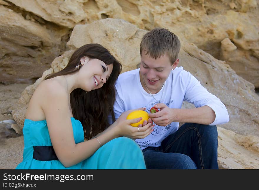 Yang woman and man enjoying themselves on the beach. Yang woman and man enjoying themselves on the beach