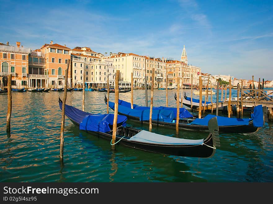 Group of gondolas docked on the water in Venice, Italy