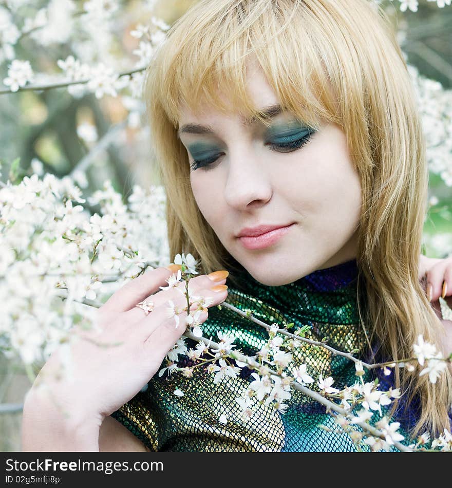 Beautiful young girl resting in spring garden. Beautiful young girl resting in spring garden