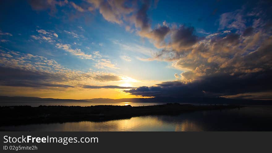 Sunset and clouds over the sea from Omisalj, Krk island, Croatia.