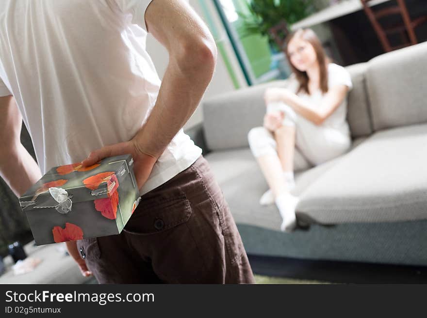 Boy with gift and girl with long hair on sofa. Boy with gift and girl with long hair on sofa