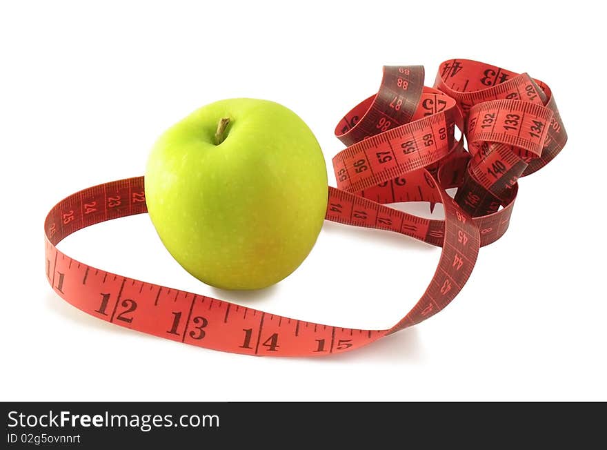 Green apple and pink measuring tape (centimetres and inches) on white background with shadow. Green apple and pink measuring tape (centimetres and inches) on white background with shadow.