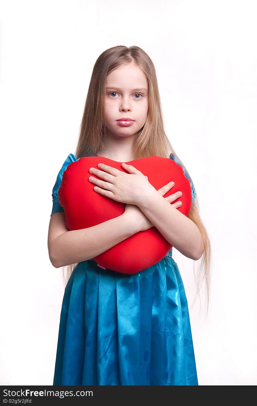 Beautiful young girl isolated on white, child with blond long hair, blue dress and red ball, studio. Beautiful young girl isolated on white, child with blond long hair, blue dress and red ball, studio