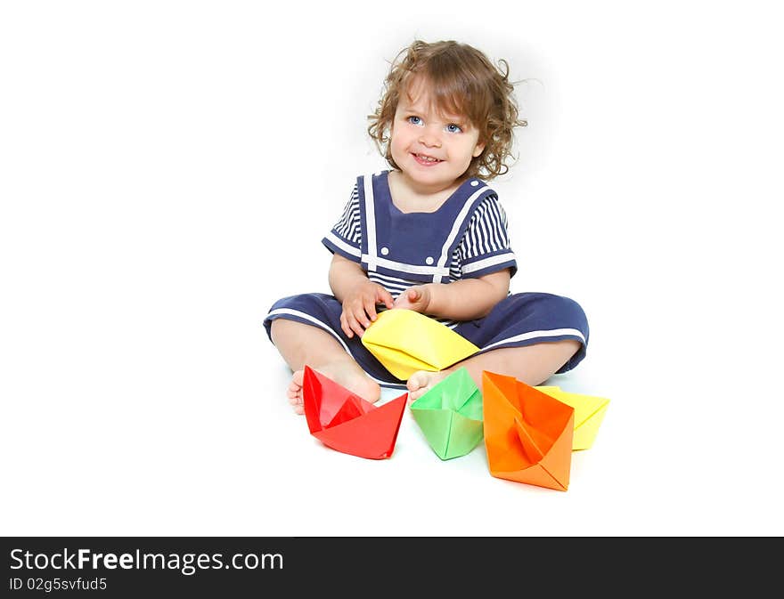 Cute toddler girl with paper ships