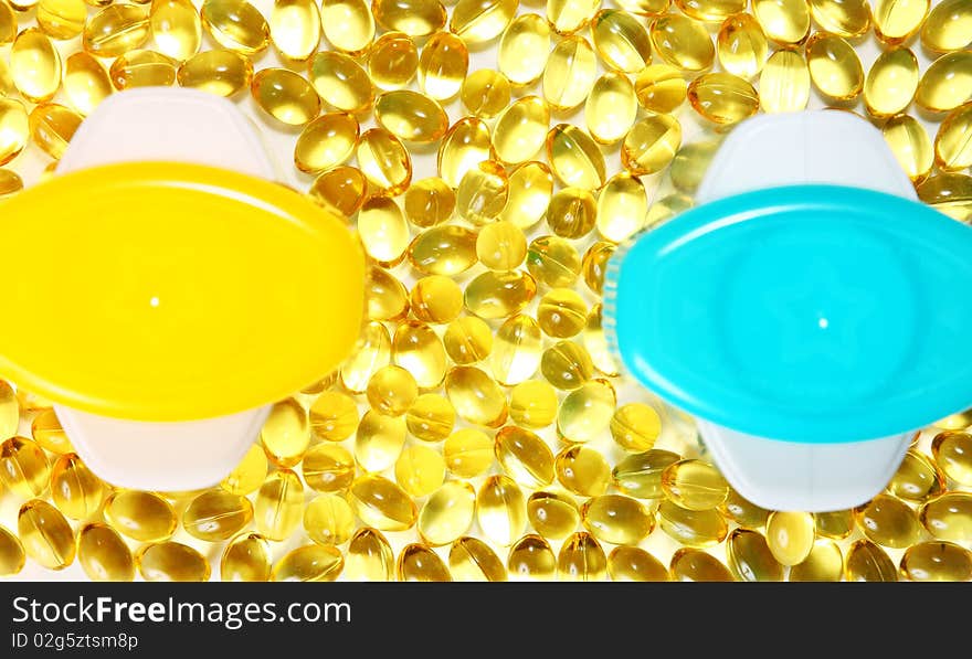 Yellow Pills (capsules) And Two Colorful Cans