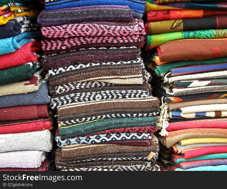 Mexican textile and tablecloths display in piles