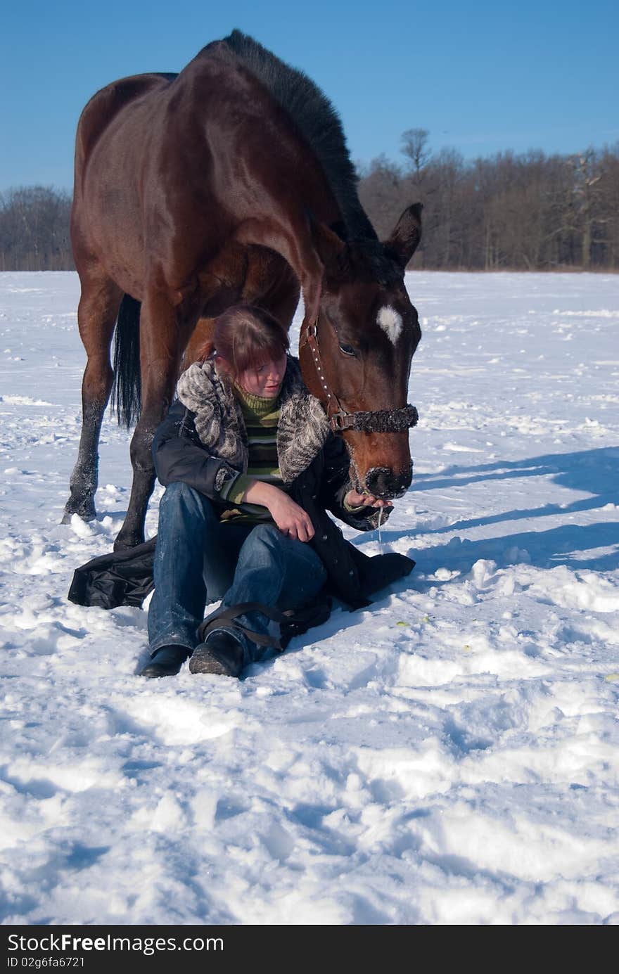 Girl feeding her horse