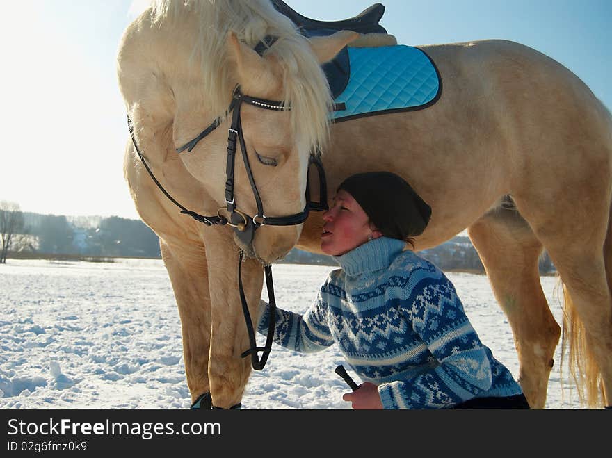 Young woman and her white horse