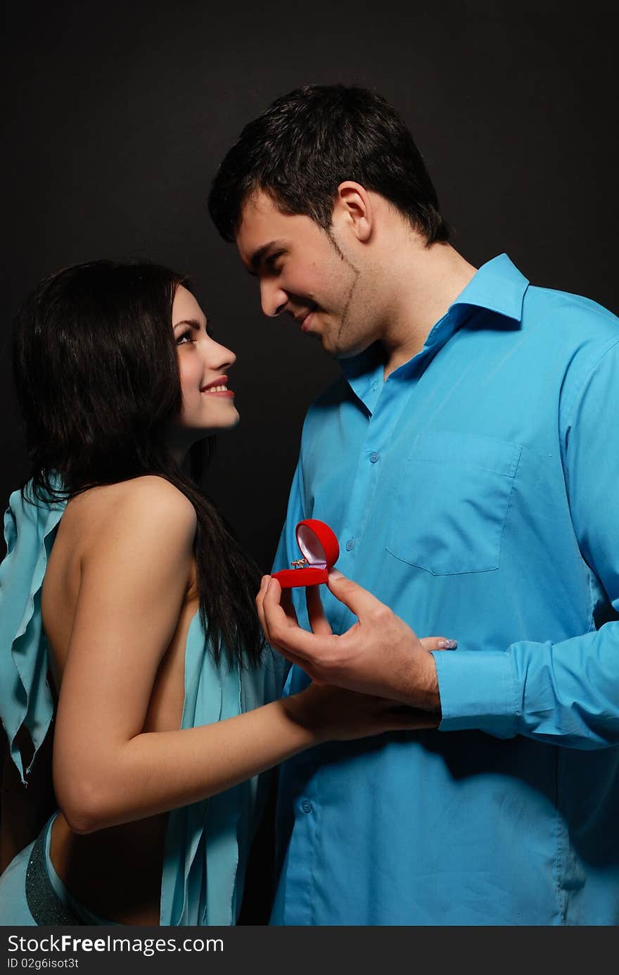 A beautiful young couple posing in studio