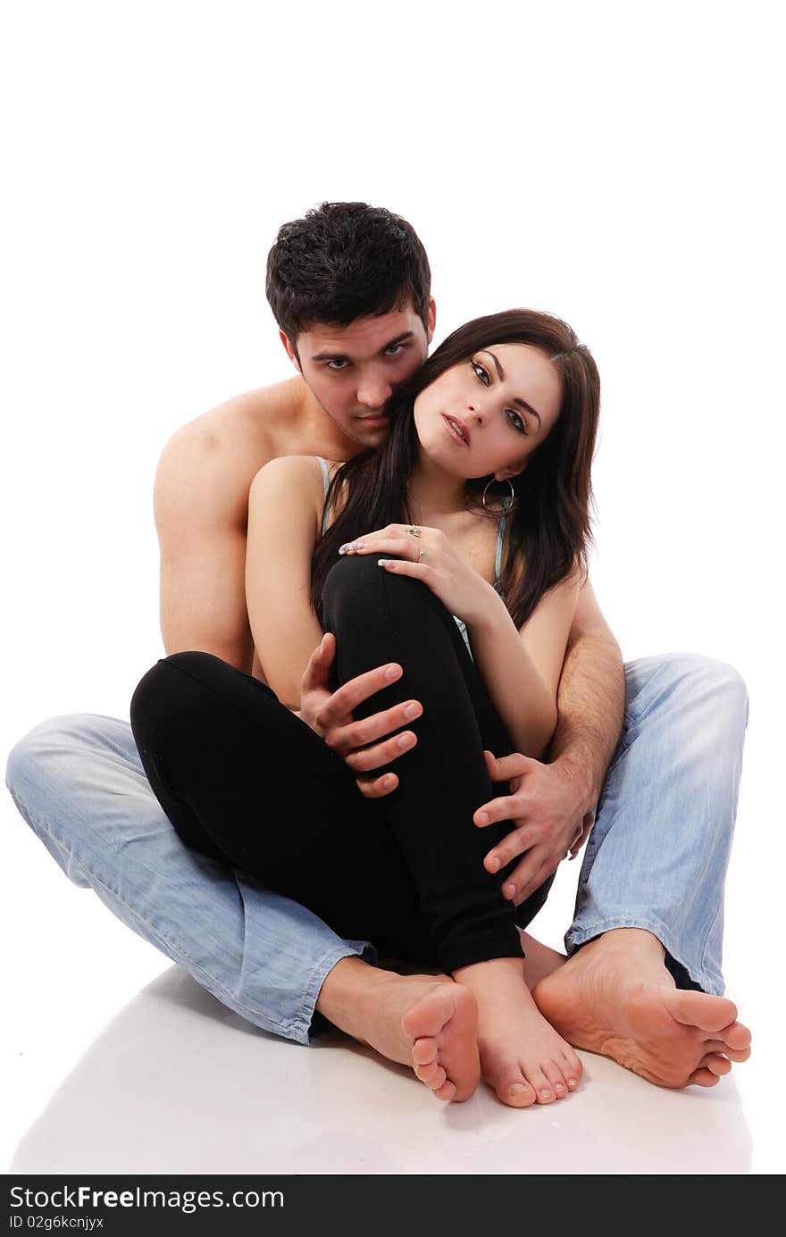 A beautiful young couple posing in studio