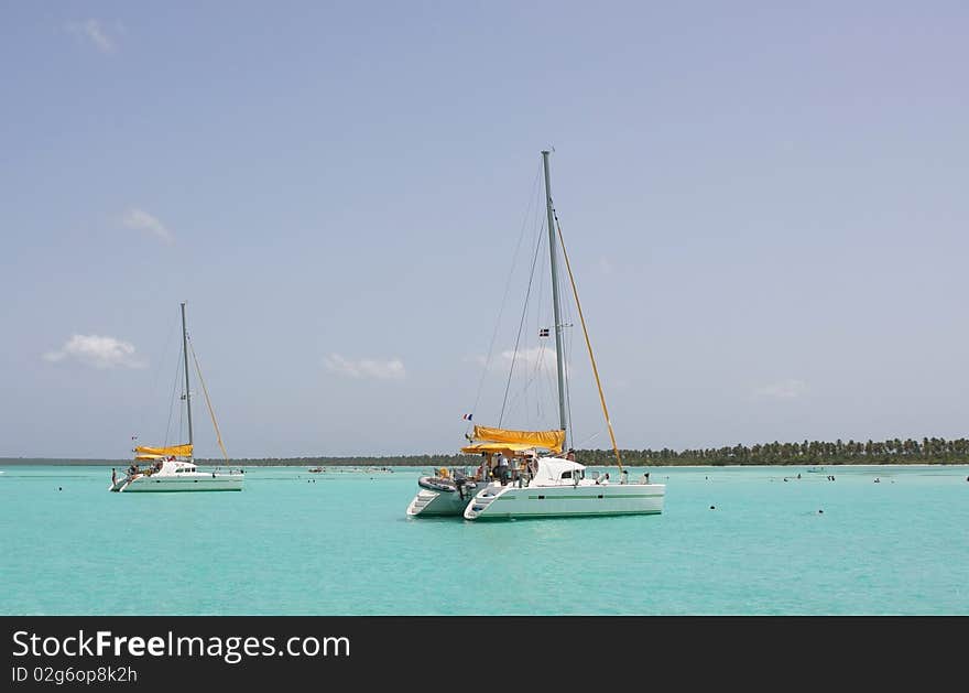 Catamarana and people swiming in caribbean sea